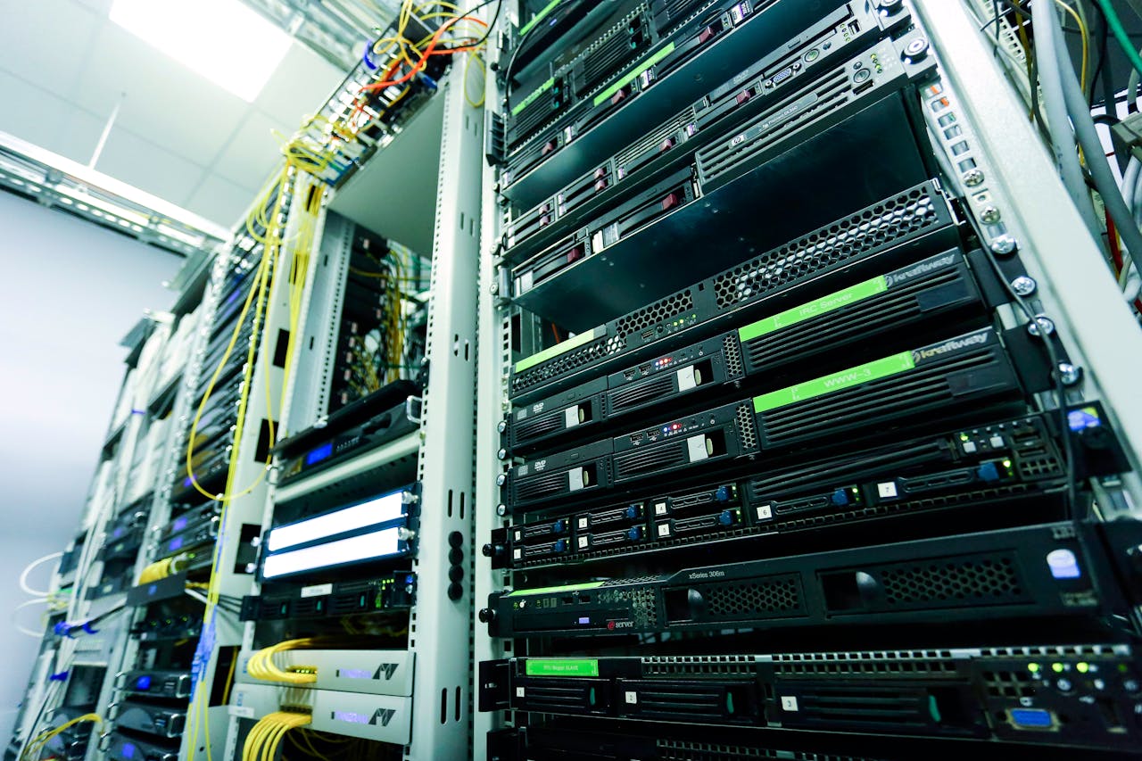 hero-img-01 High-tech server rack in a secure data center with network cables and hardware components.